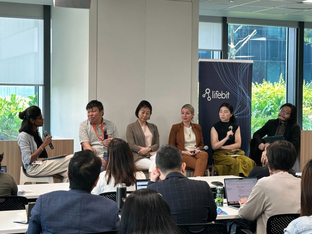 A panel discussion next to a Lifebit banner in Singapore